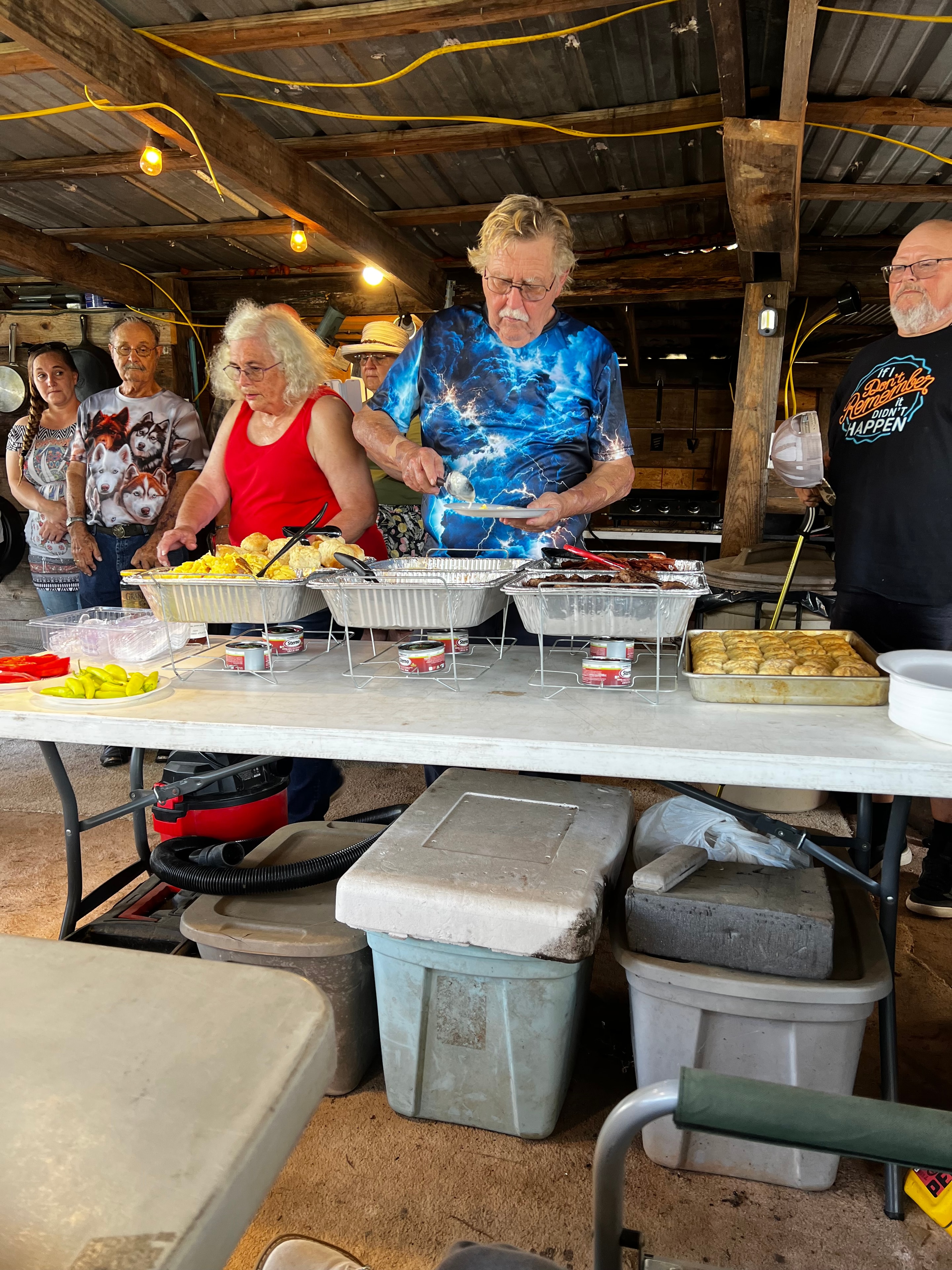 Tribal members serving the traditional feast inside the cook house at Green Tree Ceremony July 11, 2026