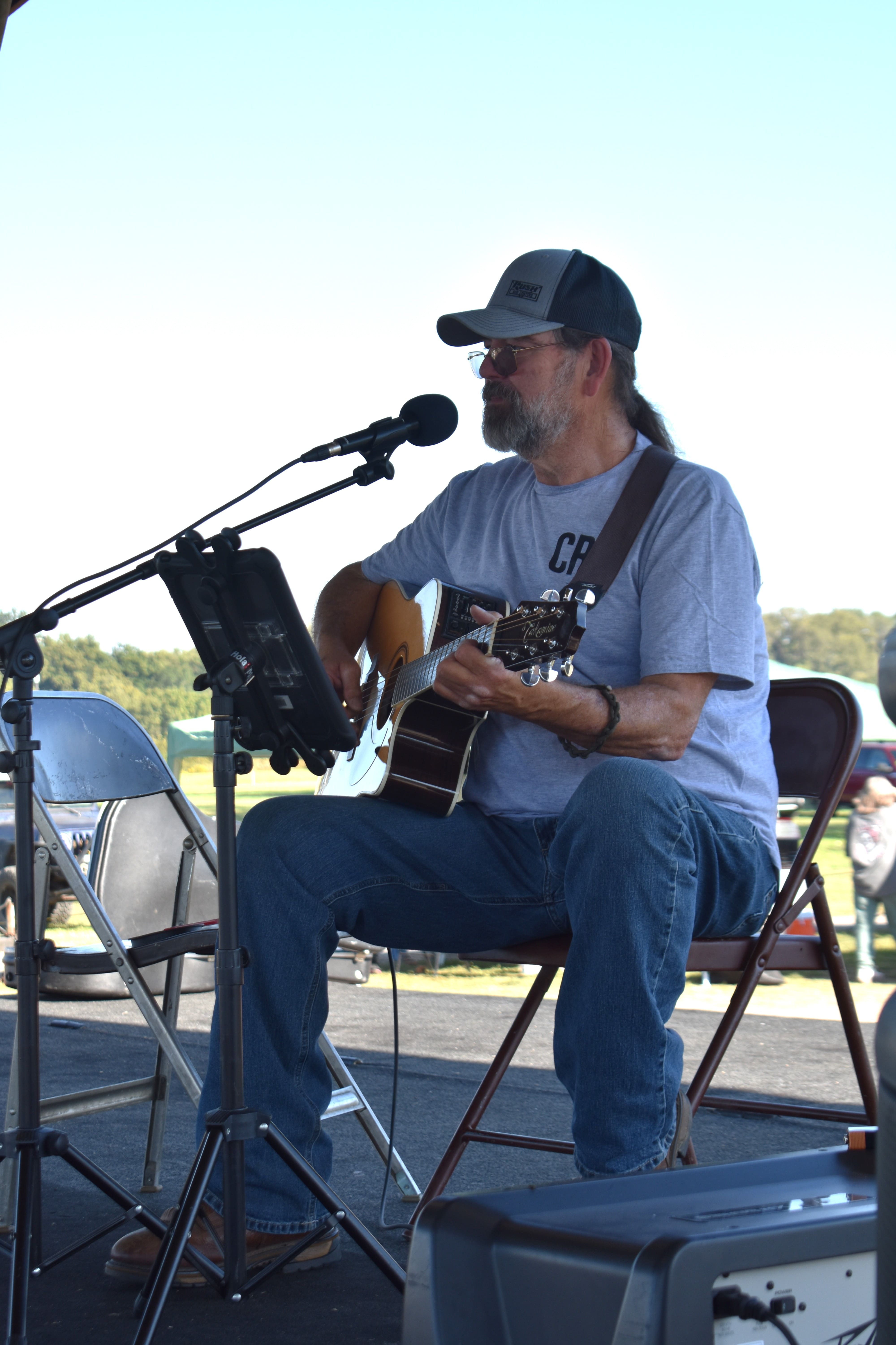 Live acoustic guitar performer on stage at October Festival 2025