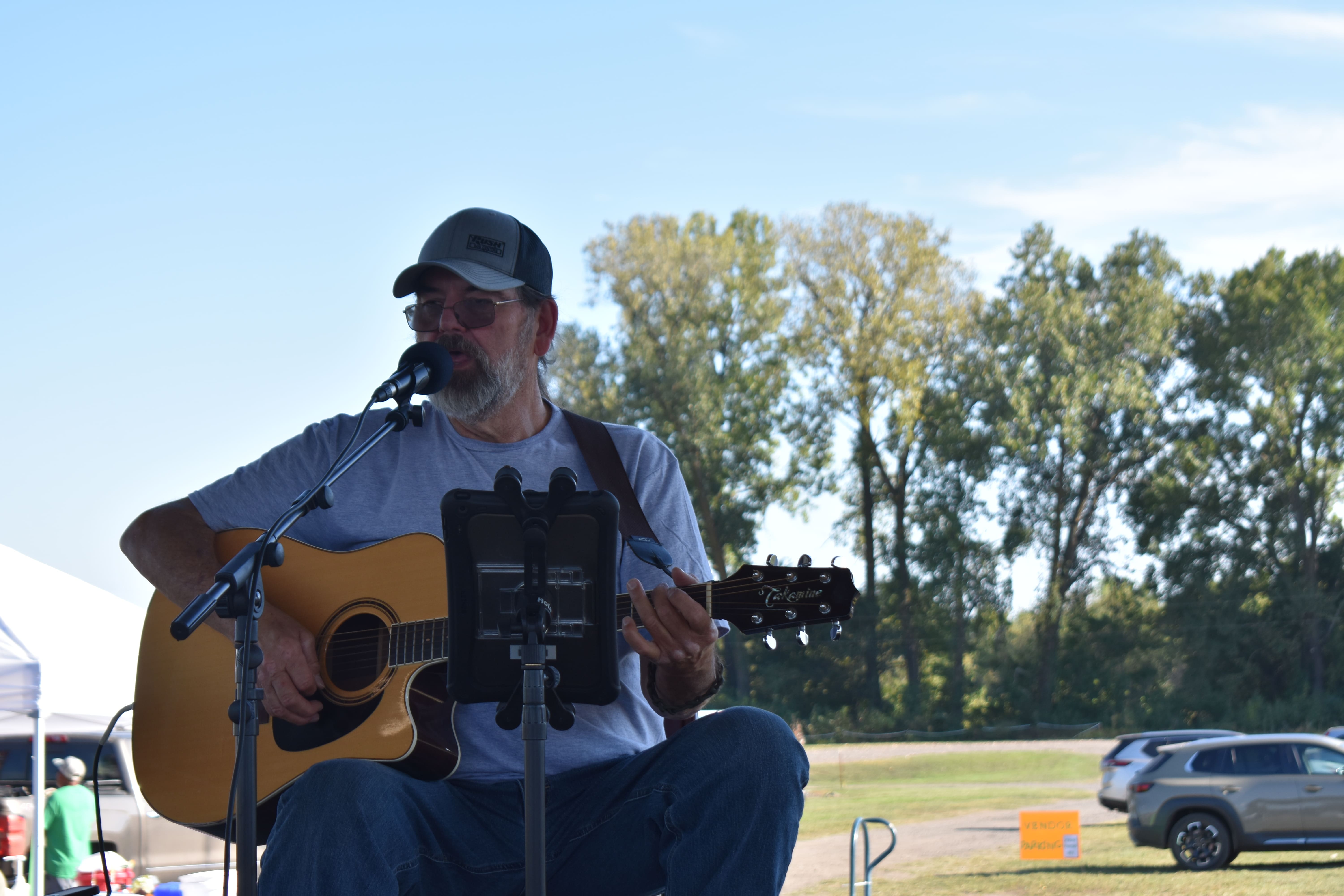 Live acoustic guitar performer on stage at October Festival 2025