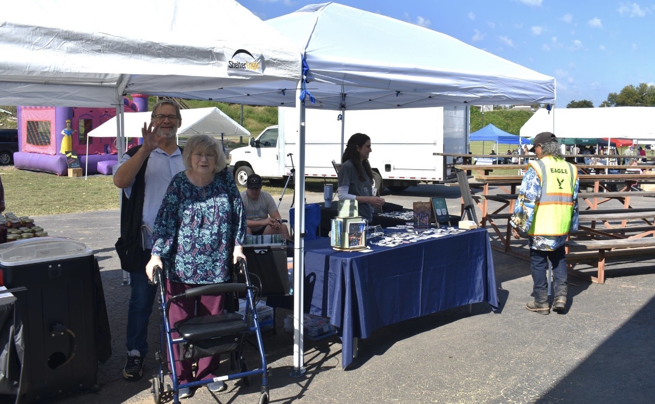 Tribal members and visitors at Cherokee Chickamauga vendor booth