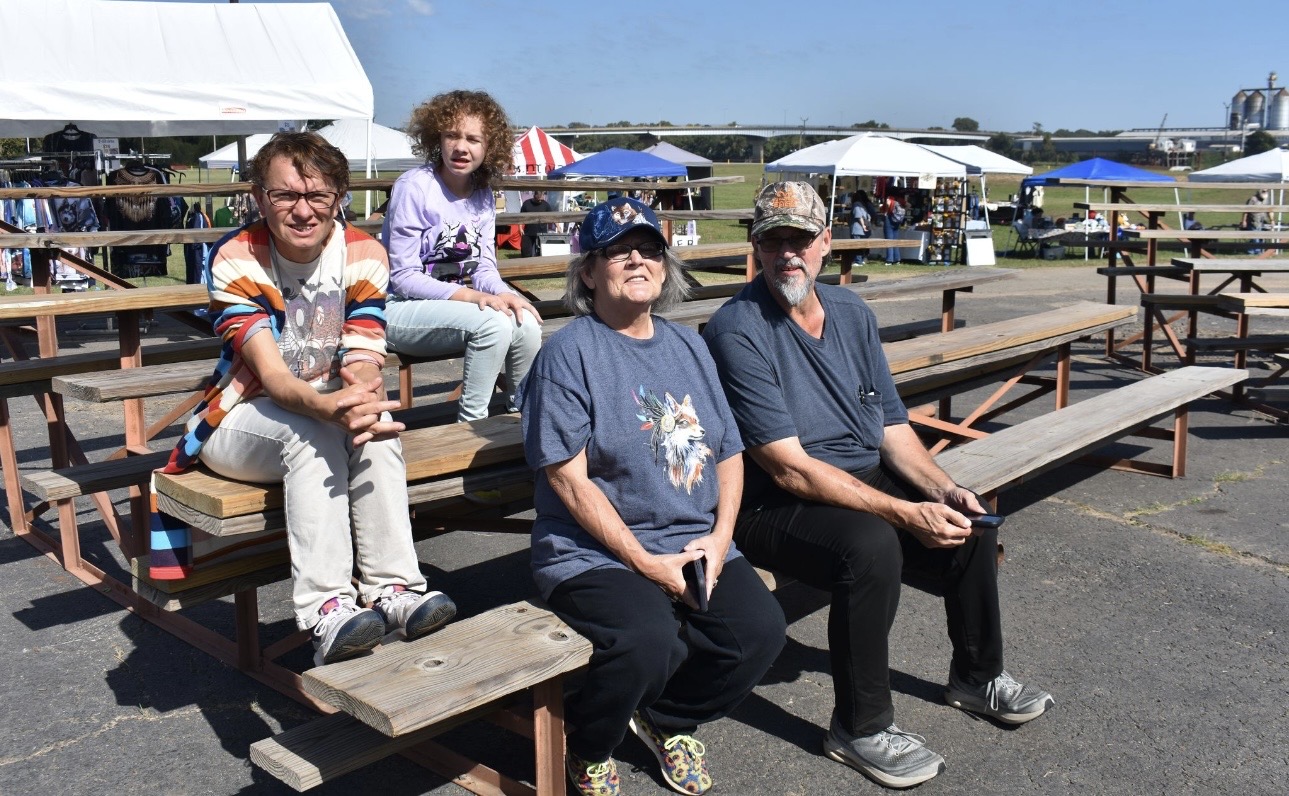 Cherokee Chickamauga family seated on bleachers at community event