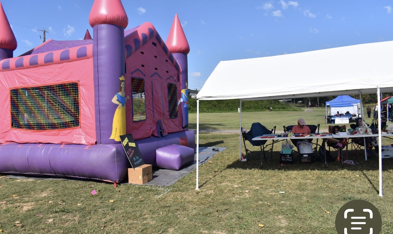 Bounce house and vendor tent at Cherokee Chickamauga community gathering