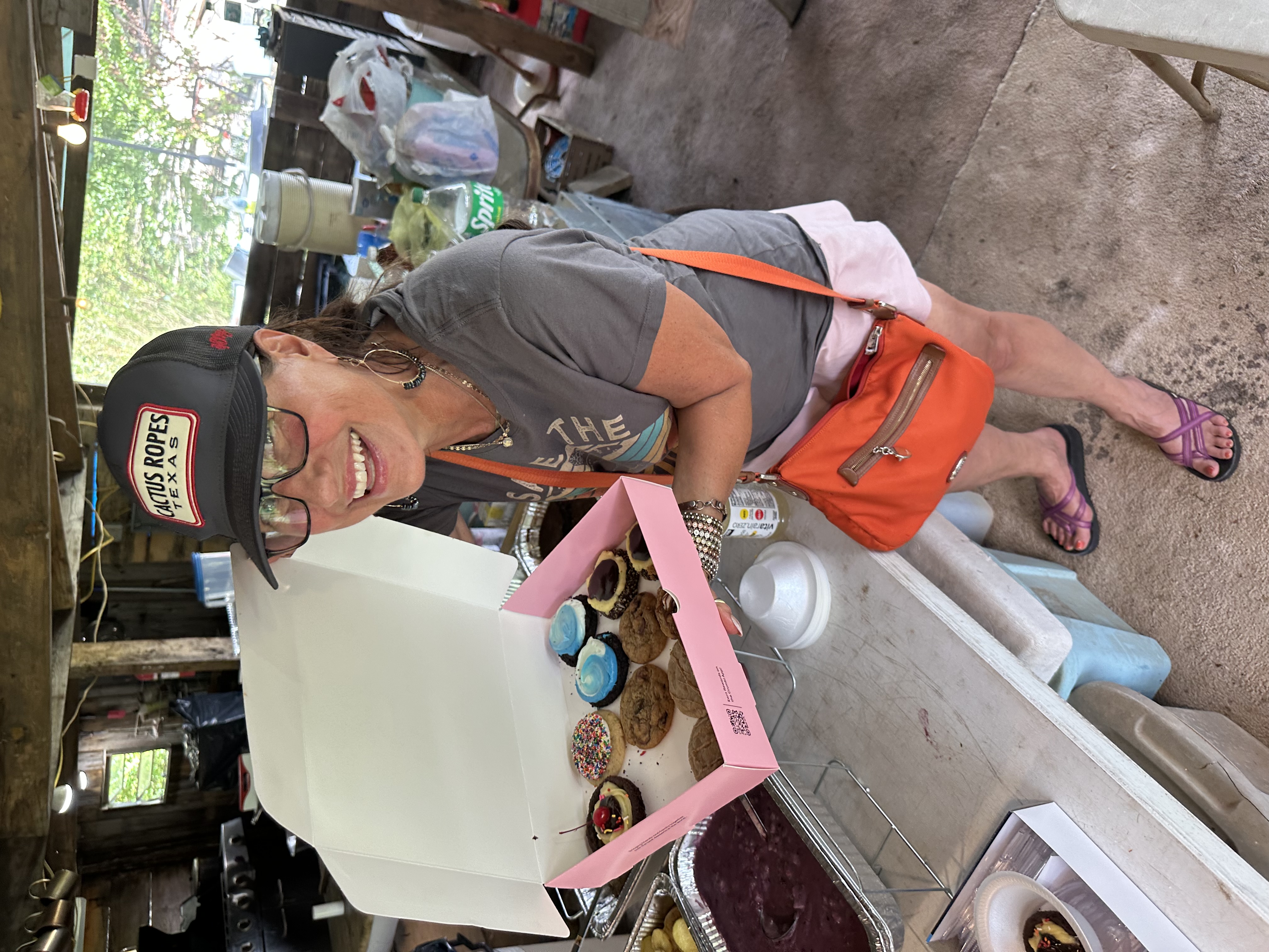 Tribal member smiling with cookies and blackberry cobbler at Green Corn Ceremony 2026