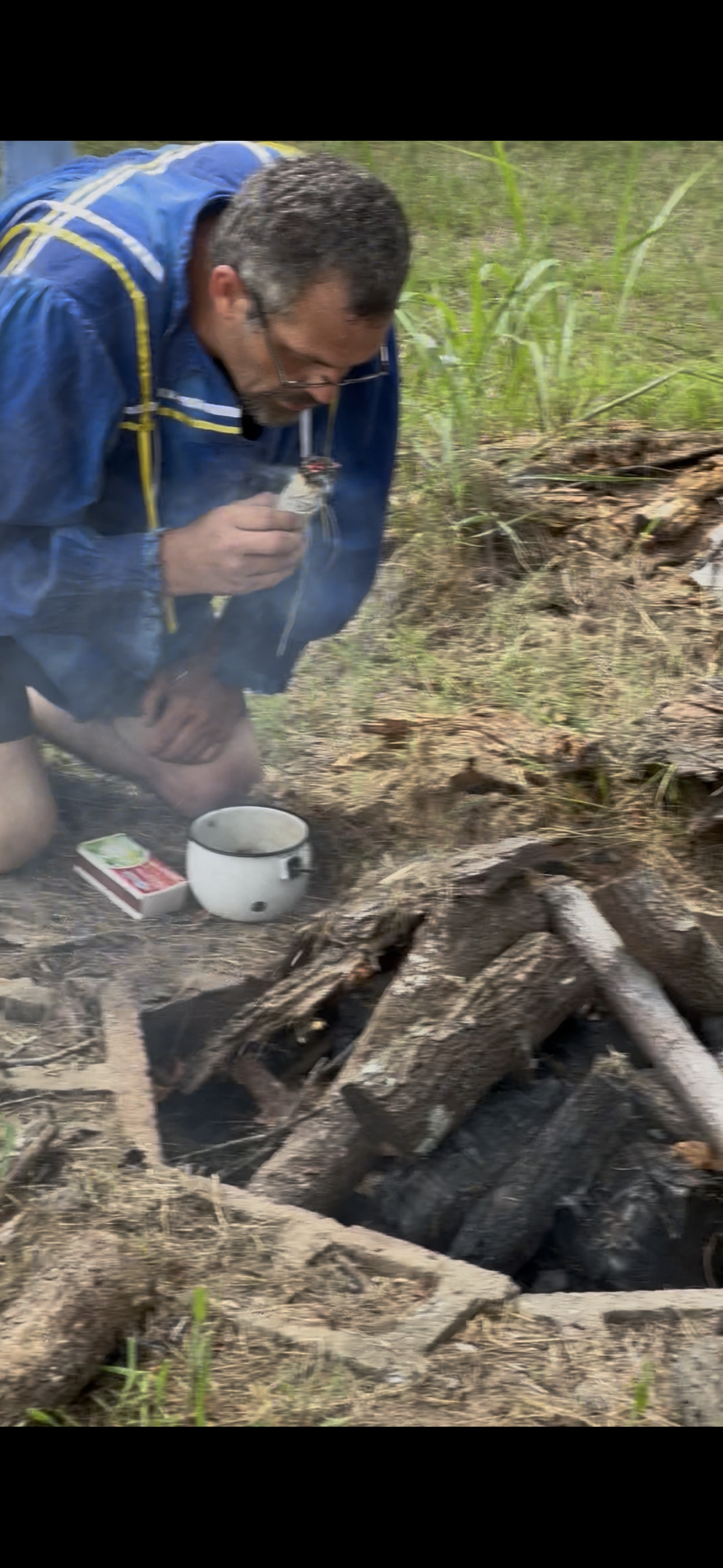 Tribal member lighting the sacred ceremonial fire at Green Corn Ceremony 2026