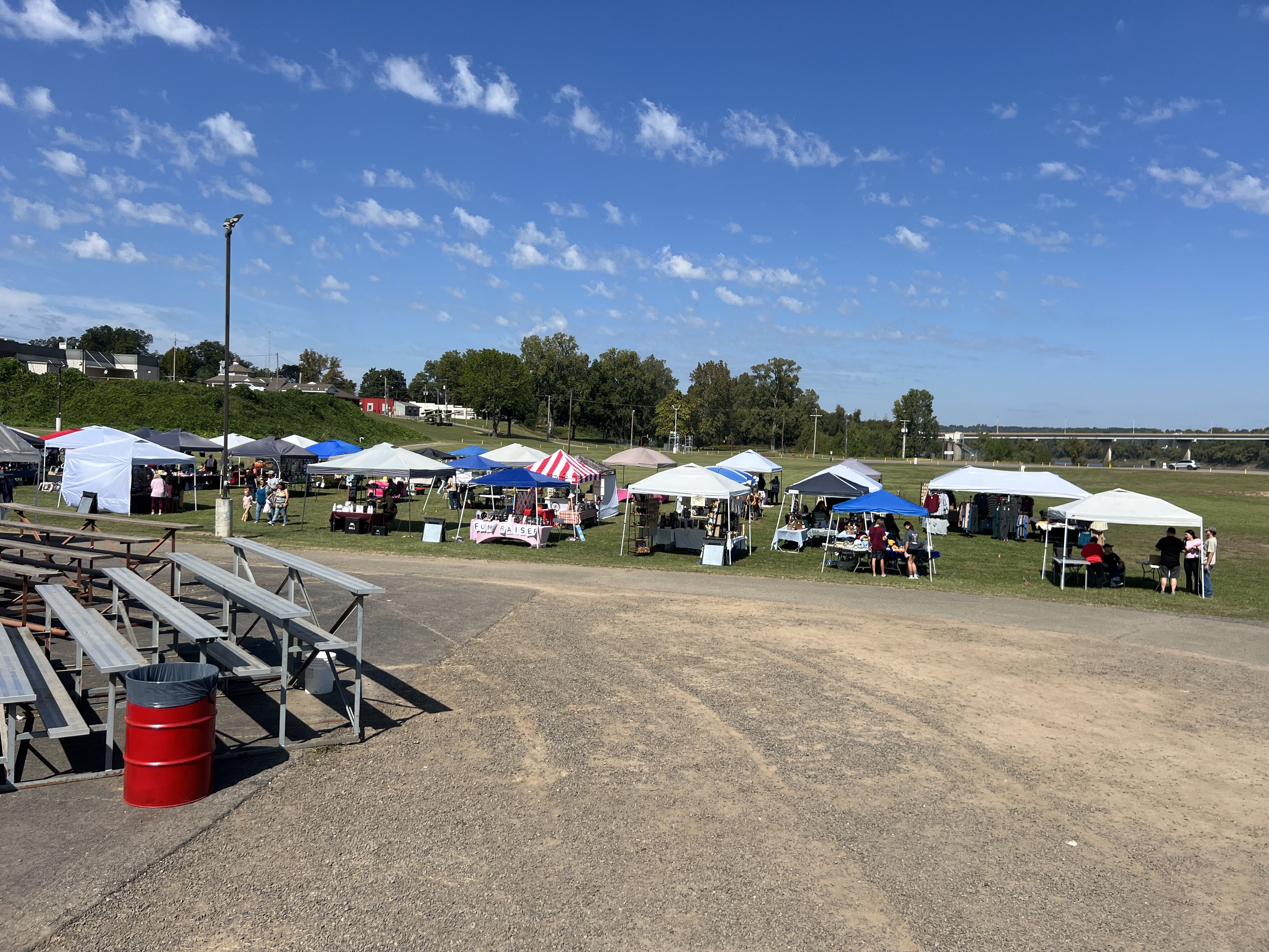 Row of colorful vendor tents along the Arkansas River at October Festival 2025